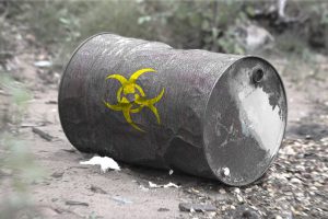 The question of sustainability versus remediation is an economic one as much as a humanitarian one. This is a photo of a toxic looking barrel laying on its side.
