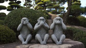 See no evil, speak no evil, hear no evil monkey statue. Some leaders favor undercommunicating as a key to power.