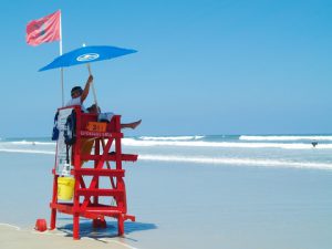 Photo of a lifeguard at the beach. Leaders who try to do everything themselves are in danger of drowning under their own hubris.