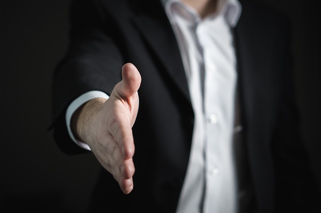 A man extending his hand for a handshake. It's hard to find a photo that represents "loyalty!"