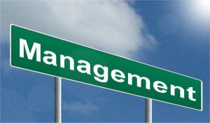 Highway management sign: The key to managing discipline in a large business setting is by establishing objective measurements, and letting associates manage their own performance.