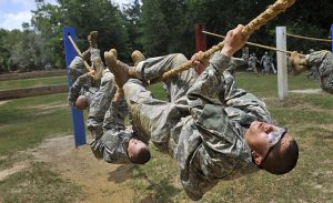 Photo of soldiers running through an obstacle course.