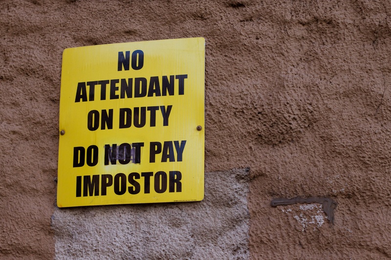 Sign that warns people, "No attendant on duty. Do not pay impostor." This is the perfect metaphor for impostor syndrome.