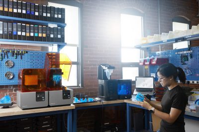 A woman works at an additive manufacturing facility