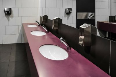 Photo of three sinks in a public bathroom. I made everyone clean the bathrooms at Robroy, including the executives.