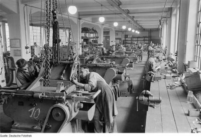 Factory machine from the 1950s. Hire people for their manufacturing skills and abilities, not their education.