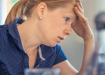 A woman who looks like she was promoted to a manager position she wasn't ready for.