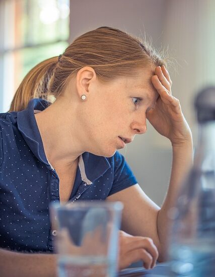 A woman who looks like she was promoted to a manager position she wasn't ready for.